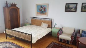 a bedroom with a bed and a chair at Vila Jitka in České Budějovice