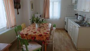 a kitchen with a table with a tablecloth on it at Vila Jitka in České Budějovice