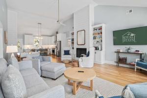 a living room with a couch and a table at Jungle House-Heated Pool-Pet Friendly-Luxury in Edisto Island
