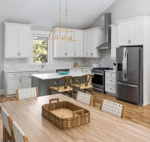 a kitchen with white cabinets and a table with a basket on it at Jungle House-Heated Pool-Pet Friendly-Luxury in Edisto Island