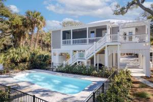 a house with a swimming pool in front of it at Jungle House-Heated Pool-Pet Friendly-Luxury in Edisto Island