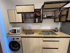 a kitchen with a sink and a washing machine at vip ghazala in Dahab