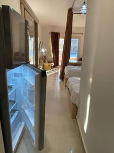 a room with an open refrigerator in a bedroom at vip ghazala in Dahab +5 photos