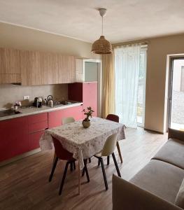 a kitchen and dining room with a table and chairs at NessunConfine Casa Laura in Santa Giuletta