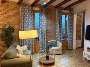 a living room with a couch and a table at OLYMPIC VILLAGE in Barcelona