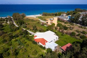 an aerial view of a house on a hill next to the ocean at Flora Beach House in Kremasti