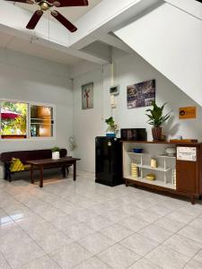 a living room with a couch and a table at Sunrise Guesthouse in Prachuap Khiri Khan