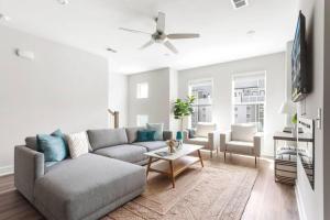 a living room with a couch and a table at The Trendy In Park Circle Mins to DT CHS & Beach in Charleston