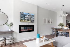 a living room with a fireplace and a table at The Trendy In Park Circle Mins to DT CHS & Beach in Charleston