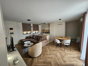 a living room with a couch and a table at Loft Apartment in Podgorica