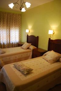 a hotel room with two beds and two lamps at Casanavalon in El Peral