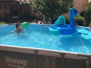 a woman in a pool with a toy duck in a swimming pool at Casanavalon in El Peral
