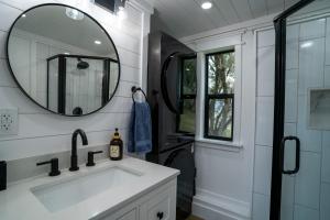a bathroom with a sink and a mirror at River Falls Retreat in Oakhurst +10 photos