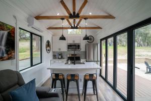 a kitchen and living room in a tiny house at River Falls Retreat in Oakhurst