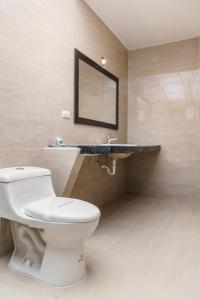 a bathroom with a white toilet and a mirror at Hotel Libertador in Loja +23 photos