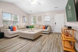 a living room with a couch and a table at The Suite Carolinas in Charleston
