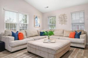 a living room with a couch and a table at The Suite Carolinas in Charleston