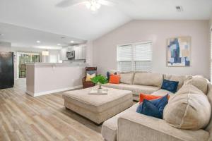 a living room with a couch and a table at The Suite Carolinas in Charleston +24 photos