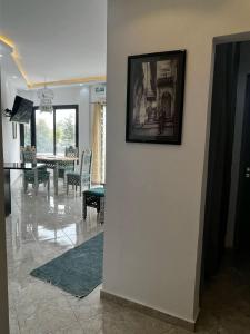 a living room with a picture on a wall at L Andalousie in Tabarka