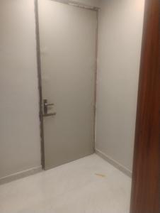 a white door in a room with a floor at Vihangam vatika in Sasarām