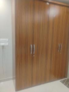 a wooden cabinet with two doors in a room at Vihangam vatika in Sasarām