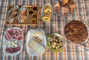 a table topped with different types of bread and pastries at B&B Ai Tre Cavalli in Cherasco