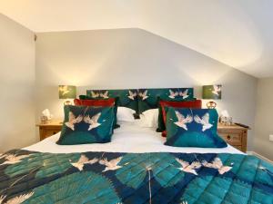 a bedroom with a bed with birds on it at Kings Head - Riverside, Ravenstonedale in Ravenstonedale