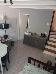 a living room with a staircase leading to a kitchen at Panchitas in Guaymallen