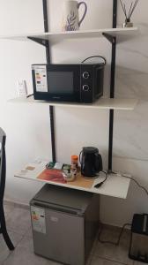 a desk with a microwave and a toaster oven on it at Panchitas in Guaymallen +4 photos