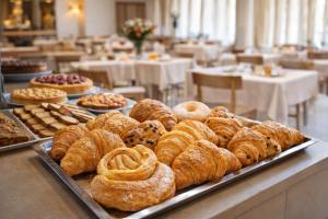a buffet of pastries and other pastries on a table at Hotel Brezza Nuova Gestione in Rimini