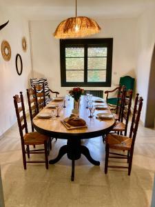 a dining room table with chairs and a chandelier at VILLA CLEMENTINE in Aignan