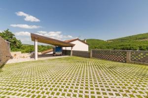 a stone patio with a pavilion in front of a house at Villa Argenta in Aržano