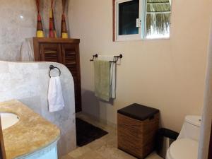 a bathroom with a sink and a toilet at Beautiful Tropical House with Ocean VIEWS! in Cruz de Huanacaxtle +26 photos