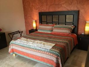 a bedroom with a large bed with two lamps at Beautiful Tropical House with Ocean VIEWS! in Cruz de Huanacaxtle