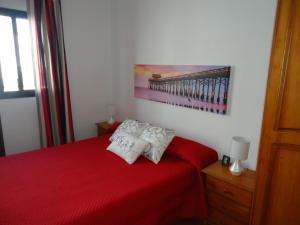 Łóżko lub łóżka w pokoju w obiekcie Apartamentos Flor del Cotillo