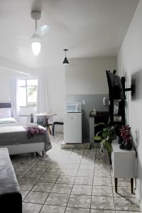 a living room with a bed and a table and a couch at Loft Recanto Dos Cavalheiros! Com Ar Condicionado! in Macaé +128 photos