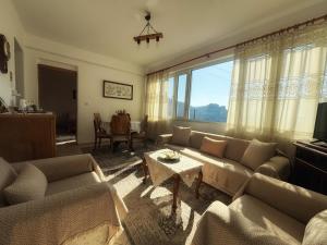 a living room with a couch and a table at Georgaras Accommodation in Platanoússa
