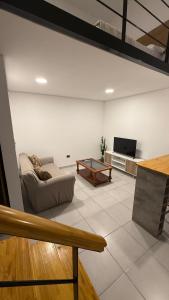 a living room with a couch and a table at Loft Horizonte Viedma in Viedma