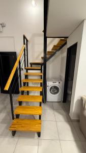 a staircase in a room with a washing machine at Loft Horizonte Viedma in Viedma +15 photos