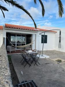 a patio with a hammock in front of a house at Casa do Profeta in Porto Santo
