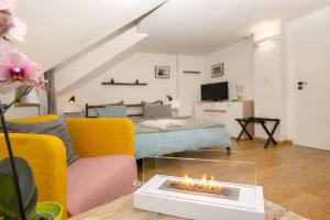 a living room with a couch and a fire place at Penzion Quest in Loket