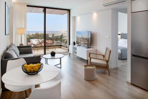 a living room with a couch and a table at L Residences & Suites in Larnaca