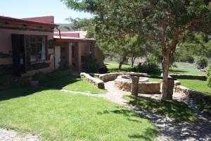 a house with a yard with grass and a fence at Karoo Saloon in Barrydale