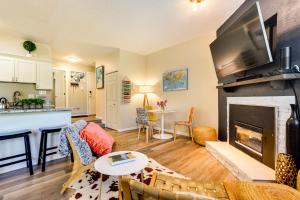 a living room with a fireplace and a kitchen at Ski Getaway! Mtn-View Condo Near Keystone Resort in Keystone