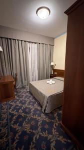 a hotel room with a bed and a window at UNITY BANK HOTEL Termale Padova RC12 in Abano Terme