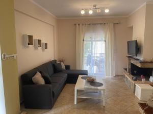 a living room with a couch and a table at Ioannis Apartment in Syvota