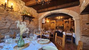 a dining room with tables and chairs in a building at La Clerecia de Ledesma in Ledesma