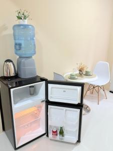 a small refrigerator with a water jug on top of it at APART LyM 2 in Clorinda