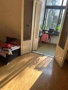 a room with a door open to a room with a table at Baraka in Cairo
