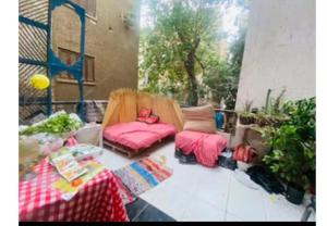 a patio with a couch and a chair and a table at Baraka in Cairo